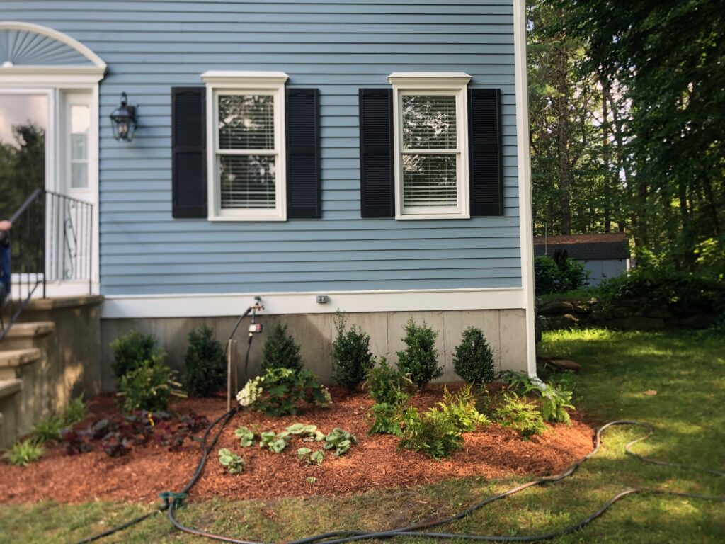 An excavator both dug out the old soil and laid the new soil. This north facing garden now has 19 shrubs and 30 perennials! Greenleaf’s Garden Design specializes in Garden Design, Maintenance, and Installation within 45 miles of Tyngsboro MA.