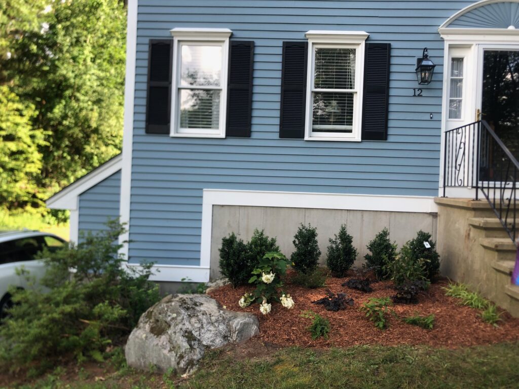An excavator both dug out the old soil and laid the new soil. This north facing garden now has 19 shrubs and 30 perennials! Greenleaf’s Garden Design specializes in Garden Design, Maintenance, and Installation within 45 miles of Tyngsboro MA.
