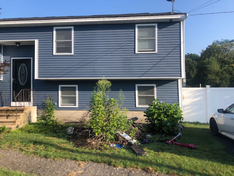 Greenleaf’s Garden Design weeded and then laid 4 yards of black mulch on this Nashua, NH property. There was a bit of pruning too. We also put in 13 mini petunias, and a red celosia.