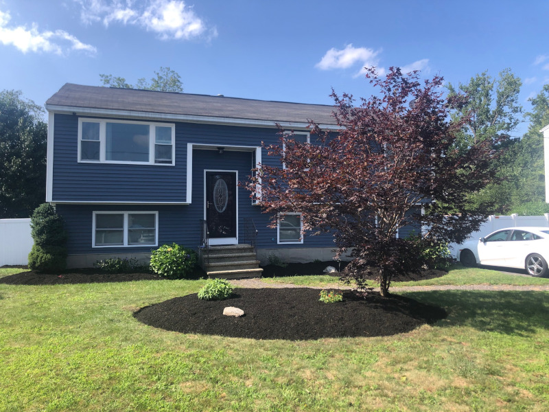 Greenleaf’s Garden Design weeded and then laid 4 yards of black mulch on this Nashua, NH property. There was a bit of pruning too. We also put in 13 mini petunias, and a red celosia.