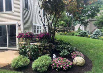 This client in Merrimack, NH, had 2 yards of mulch delivered. Our crew from Greenleaf’s Garden Design spread it the same day. It turns out he needed another yard to finish. A week later we returned to spread the rest.