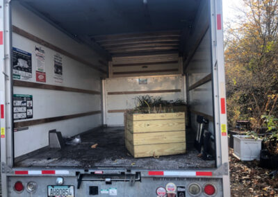 This Byfield, MA client had to move his plants from Brookline to Byfield. It took an hour to drive there. We unloaded the U-Haul truck with the Dingo Forks. It took an hour for the crew from Greenleaf’s Garden Design to move the 15 planter boxes/whiskey barrels.