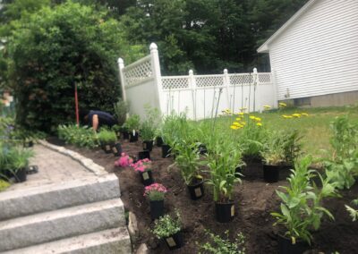 This fun project in Hudson, NH had the crew revisiting and revamping one of our existing gardens! The Excavator dug out 10 yards of poor soil and replaced it with 10 yards of good soil. Last year , in early July, we planted 100 perennials of which half were shade and the others sun loving. These new 80 perennials really made the front side and back yard pond garden quite lovely.