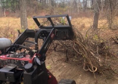 Garden Maintenance and Garden Installation in Merrimack, NH. Our Merrimack, NH client had us pull out honeysuckle bushes and bittersweet with the Dingo. We then planted 25 Staghorn and 25 Low Grow Sumac along a riverbank. Each hole had 3 shovels of compost.