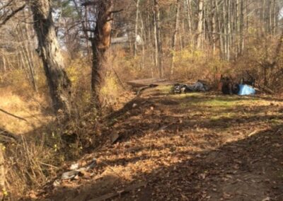 Garden Maintenance and Garden Installation in Merrimack, NH. Our Merrimack, NH client had us pull out honeysuckle bushes and bittersweet with the Dingo. We then planted 25 Staghorn and 25 Low Grow Sumac along a riverbank. Each hole had 3 shovels of compost.