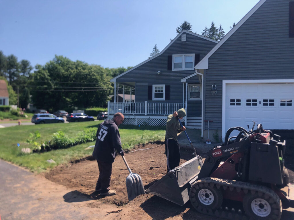 We were called in to see if this old garden in Billerica, MA with bittersweet could be saved. I said the best bet is to dig everything up and go down 8” deep. The Dingo made short work of removing the 7 yards of soil and then replacing it. The new 30 summer focused flowering perennials made the bunnies mad because the fence will keep them out!! This garden took 6 hours to complete.