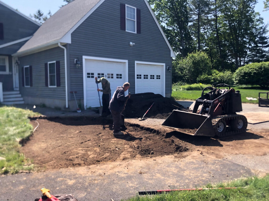 We were called in to see if this old garden in Billerica, MA with bittersweet could be saved. I said the best bet is to dig everything up and go down 8” deep. The Dingo made short work of removing the 7 yards of soil and then replacing it. The new 30 summer focused flowering perennials made the bunnies mad because the fence will keep them out!! This garden took 6 hours to complete.